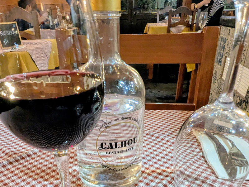 Restaurant table with wine and water bottle.